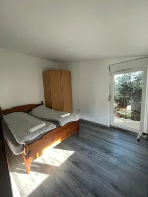 a bedroom with a bed and a large window at Vracar Apartment in Belgrade