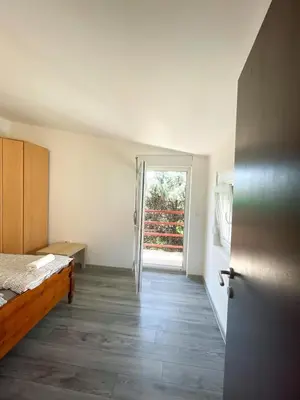 a room with a bed and a door to a room at Vracar Apartment in Belgrade