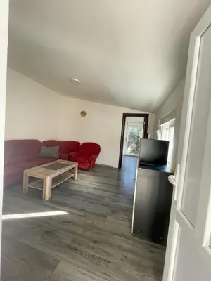 a living room with a red couch and a table at Vracar Apartment in Belgrade