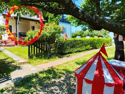 a red and white tent under a tree in a yard at KosMaj Dan Belgrade, Sopot in Belgrade