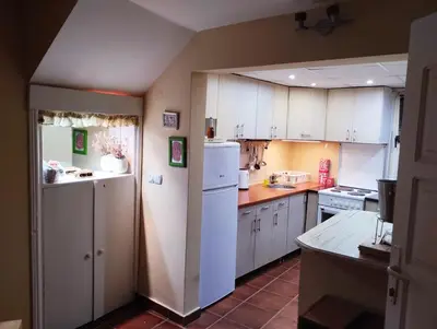 a kitchen with white cabinets and a white refrigerator at KosMaj Dan Belgrade, Sopot in Belgrade