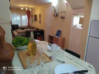 a table with glasses and a bottle on top of it at KosMaj Dan Belgrade, Sopot in Belgrade