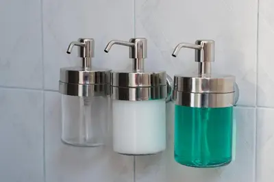 two soap dispensers on a bathroom wall with soap at Quiet Luxury Family Apt Belgrade Fortress Center in Belgrade