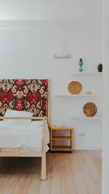 a bedroom with a bed and a wooden floor at BGLAB Salon Apartment in Belgrade