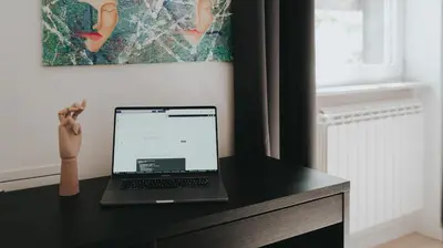 a laptop computer sitting on top of a black desk at BGLAB Salon Apartment in Belgrade