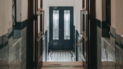 an empty corridor with a black door in a building at BGLAB Salon Apartment in Belgrade