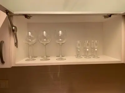 a row of wine glasses sitting on a shelf at New Sky Terrace in Belgrade