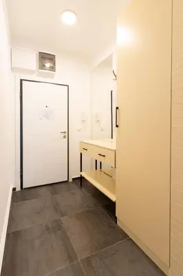a bathroom with a white door and a vanity and a mirror at President Apartman 8 in Vračar (historical)