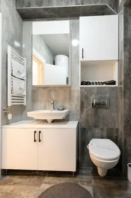 a bathroom with a white sink and a toilet at President Apartman 8 in Vračar (historical)