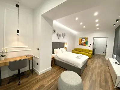 a hotel room with a bed and a desk and a desk at MONI Downtown Luxury Apartments in Belgrade