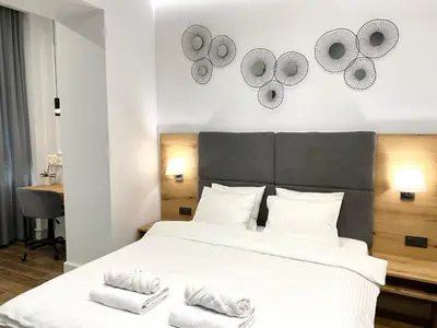 a bedroom with a large bed with towels on it at MONI Downtown Luxury Apartments in Belgrade