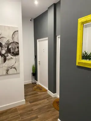 a hallway with a painting on the wall and a door at MONI Downtown Luxury Apartments in Belgrade
