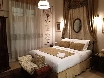 a bedroom with a large bed and a chair at VANSVEL Boutique Apartment 8 in Belgrade