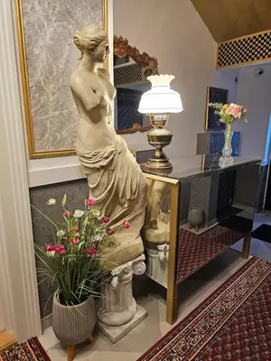 a statue of a woman in a room with a lamp at VANSVEL Boutique Apartment 8 in Belgrade