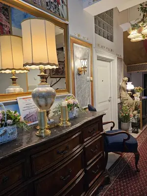 a room with a dresser with a lamp and a mirror at VANSVEL Boutique Apartment 8 in Belgrade