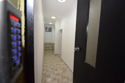 a door leading to a hallway with a tile floor at Apartments Wolf in Belgrade