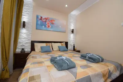 a bedroom with a bed with two pillows on it at Apartments Wolf in Belgrade