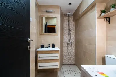 a bathroom with a sink and a shower at Apartments Wolf in Belgrade