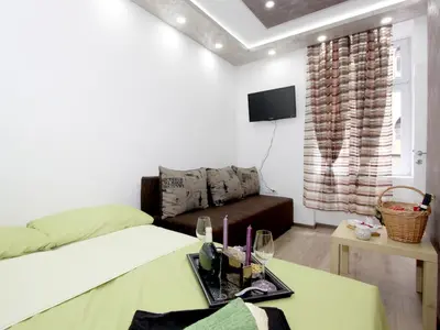 a room with a bed and a couch and a table at Apartment Savska in Belgrade