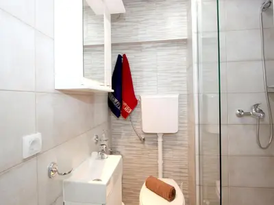 a bathroom with a toilet and a sink and a shower at Apartment Savska in Belgrade