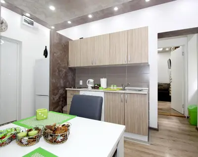 a kitchen with a white counter and a table at Apartment Savska in Belgrade
