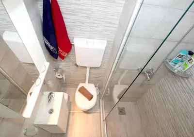 a bathroom with a toilet and a sink and a shower at Apartment Savska in Belgrade