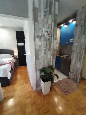 a bedroom with a bed and a potted plant at Apartment MrC , FREE PARKING in Bežanija