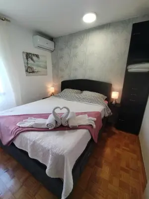 a bedroom with a bed with two towels on it at Apartment MrC , FREE PARKING in Bežanija