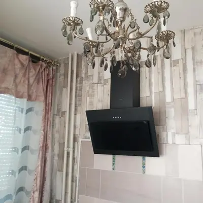 a chandelier with a flat screen tv on a wall at Apartment MrC , FREE PARKING in Bežanija