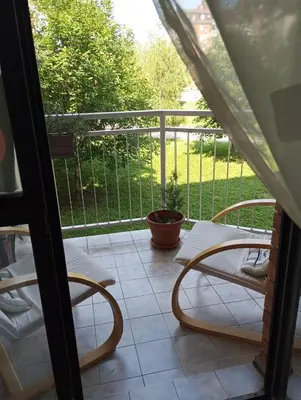 a balcony with two chairs and a table at Apartment MrC , FREE PARKING in Bežanija