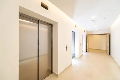 a corridor of an office building with sliding doors at Belgrade Waterfront Bramar in Belgrade