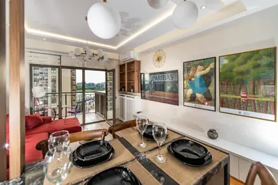 a dining room with a table with wine glasses at Belgrade Waterfront Bramar in Belgrade