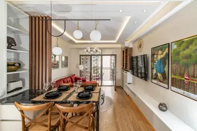 a dining room and living room with a table and chairs at Belgrade Waterfront Bramar in Belgrade