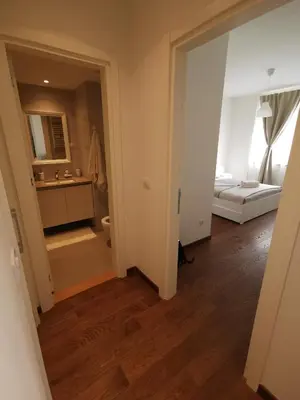 a room with a bathroom and a bedroom with a bed at Beograd na vodi -Belgrade Waterfront BW in Sajmište