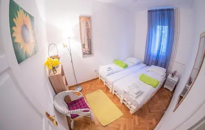 a small bedroom with a bed and a table at Hostel Beogradjanka in Belgrade
