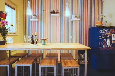 a table with chairs and a table with wine glasses at Hostel Beogradjanka in Belgrade
