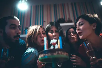 a group of people standing around a cake at Hostel Beogradjanka in Belgrade