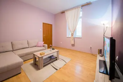 a living room with a couch and a tv at Sasa's House in Belgrade