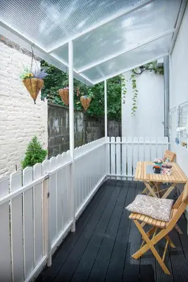 a patio with awning and a table and a chair at Sasa's House in Belgrade