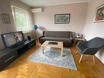 a living room with a couch and a table at Hill Apartment in Belgrade