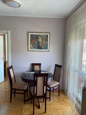 a dining room with a table and chairs at Hill Apartment in Belgrade