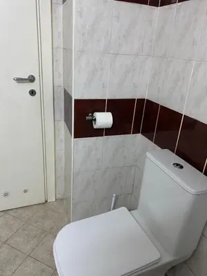 a bathroom with a toilet and a glass shower at Hill Apartment in Belgrade