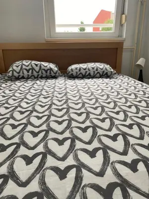 a bedroom with a bed with hearts on it at Hill Apartment in Belgrade