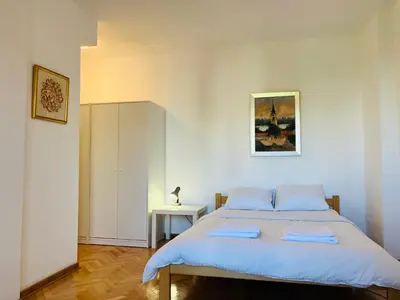 a bedroom with a large bed with blue sheets at Njegoševa in Belgrade