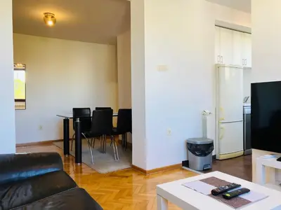 a living room with a couch and a table with chairs at Njegoševa in Belgrade