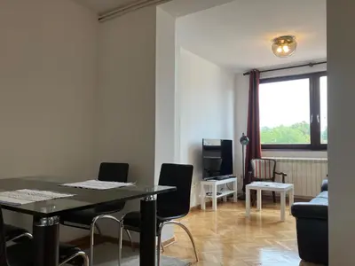 a living room with a table and chairs and a couch at Njegoševa in Belgrade