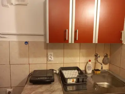 a kitchen counter with a toaster and a sink at Cosy Rooftop studio with balcony in Belgrade