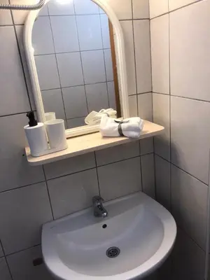 a bathroom with a sink and a mirror at Cosy Rooftop studio with balcony in Belgrade