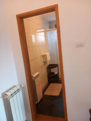 a bathroom with a walk in shower with a mirror at Cosy Rooftop studio with balcony in Belgrade