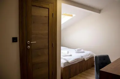 a small bedroom with a bed and a door at ELEVENROOMS in Belgrade